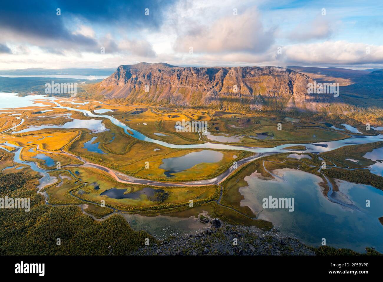Beautiful, wild arctic valley viewed from mountain top in epic early morning light. Remote Rapa river valley from the top of Skierfe in Sarek national Stock Photo