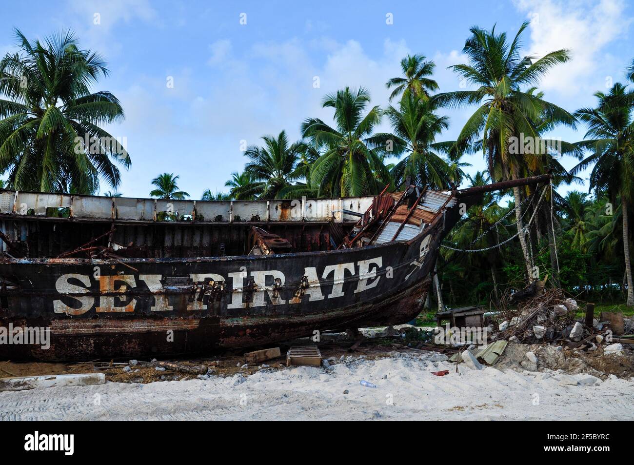 Rusty old pirate ship on the shore of the island. La Digue island ...