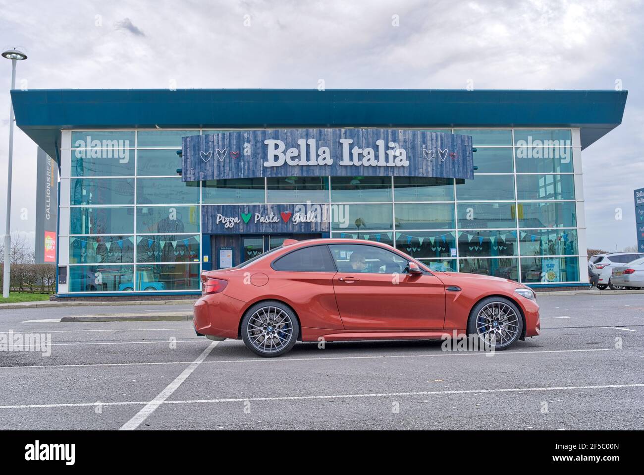 BMW parked outside Bella Italia restaurant which is closed in covid-19 pandemic across the world, England Stock Photo
