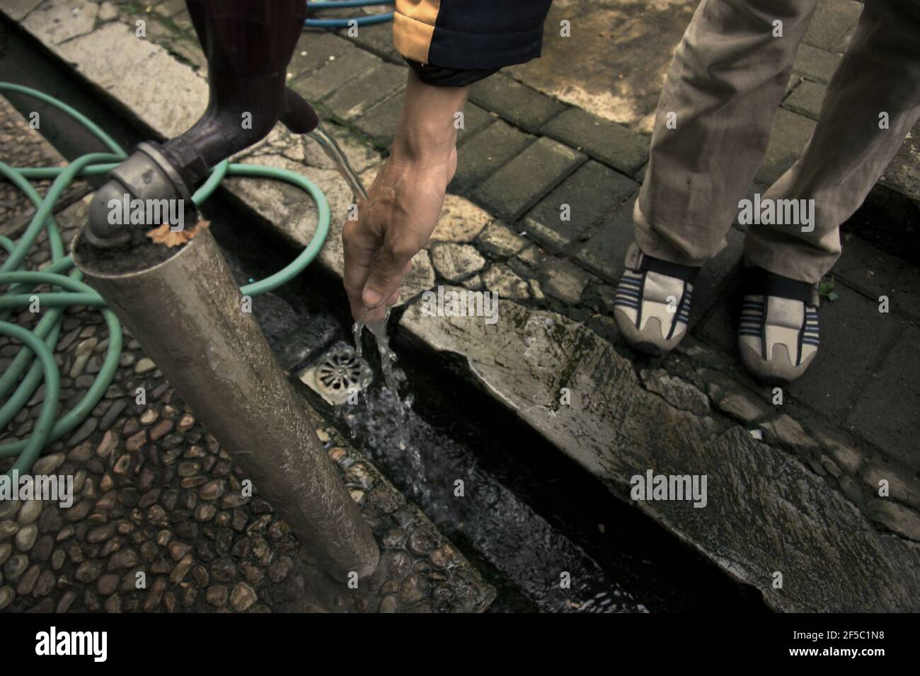 A water tap above a drainage equipped with plugholes to make sure the waste water will be absorbed by the ground, at the yard of a school in Jakarta, Indonesia. According to UN Water in their Summary Progress Update 2021 published on March 1, 2021 in Geneva, since 2015, water-use efficiency has increased by 4% globally. 'With 17 percent of available water resources being withdrawn, the world as a whole is not considered water-stressed. However, this number hides stark regional differences: in some regions the level of water stress has increased by 35 percent during the last two decades.' Stock Photo