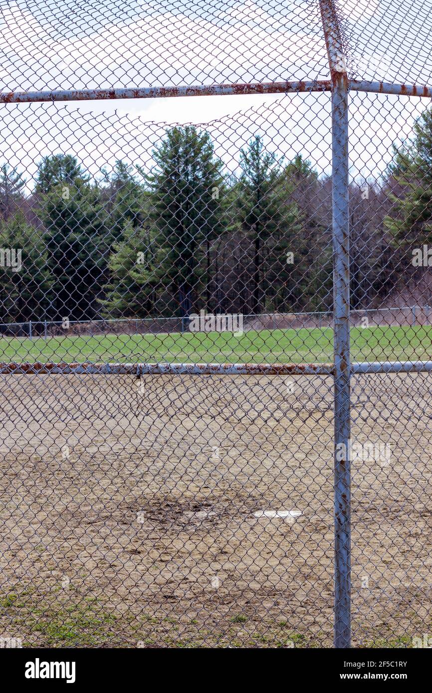 metal chain link back stop at baseball field Stock Photo