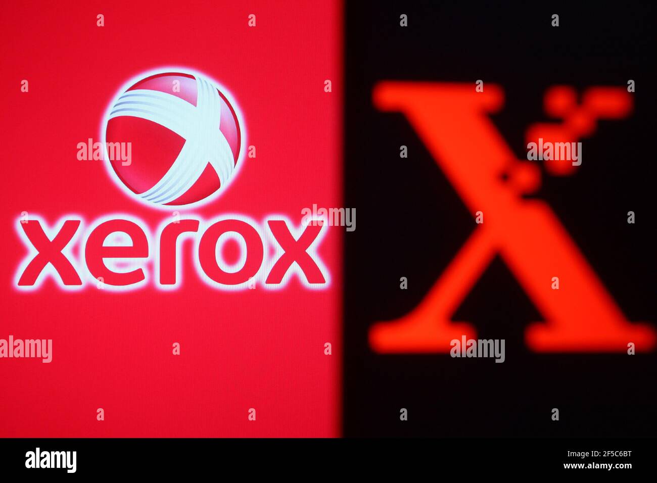 In this photo illustration the Xerox logo is seen on a smartphone and a pc screen. Stock Photo