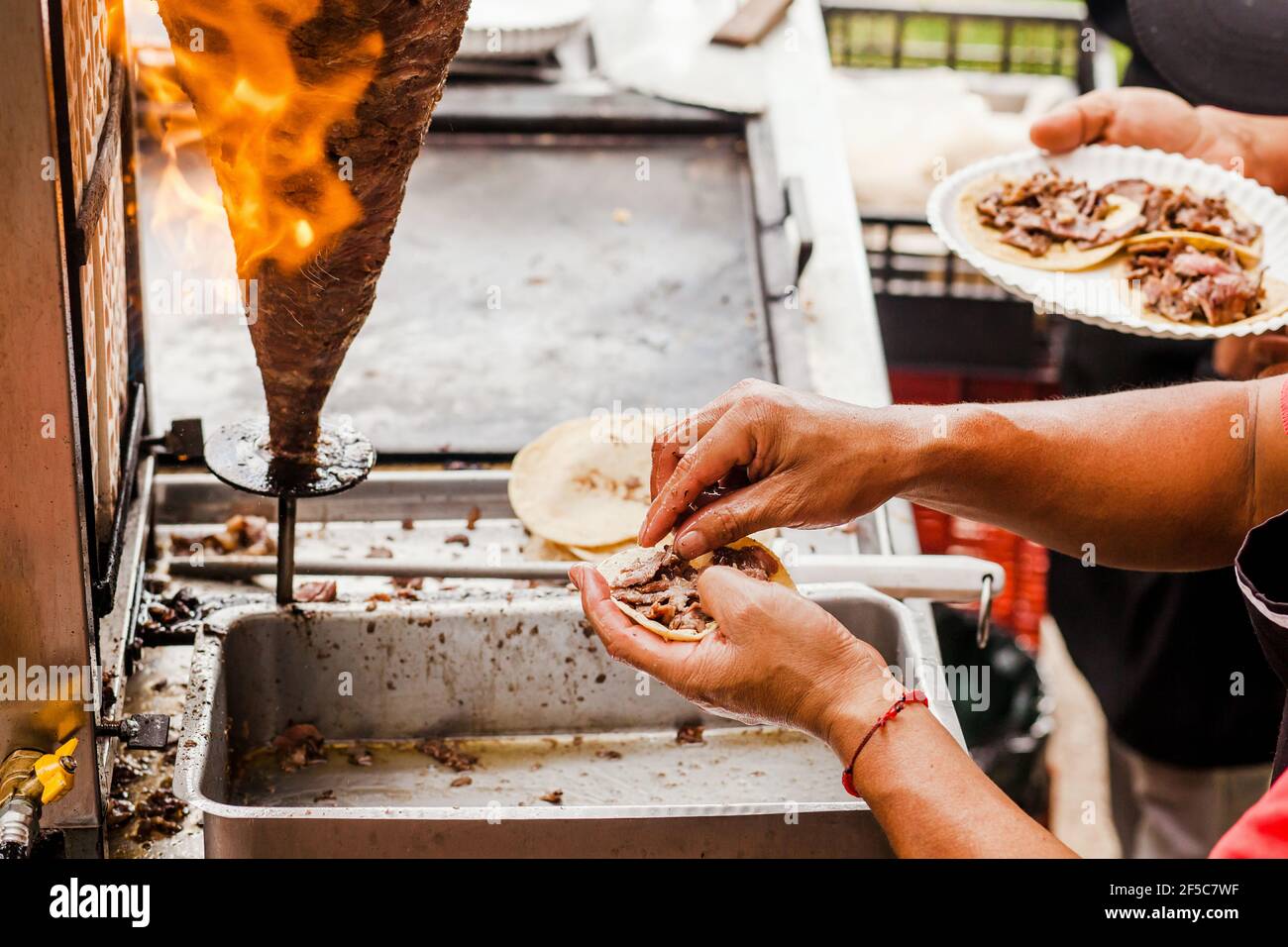cooking Mexican tacos with beef, traditional street food in Mexico city