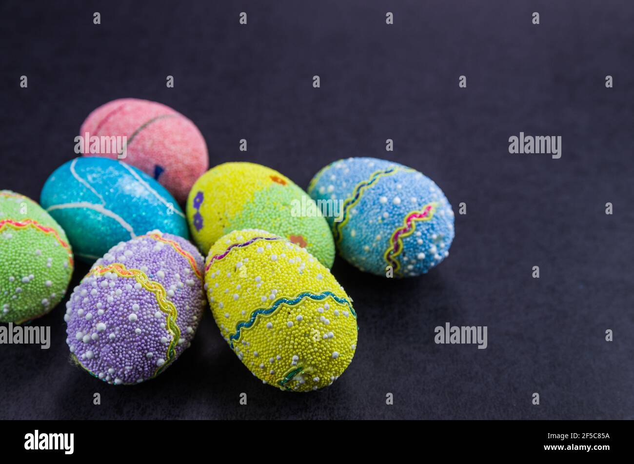 Colorful Easter eggs on a trendy black background. Stock Photo