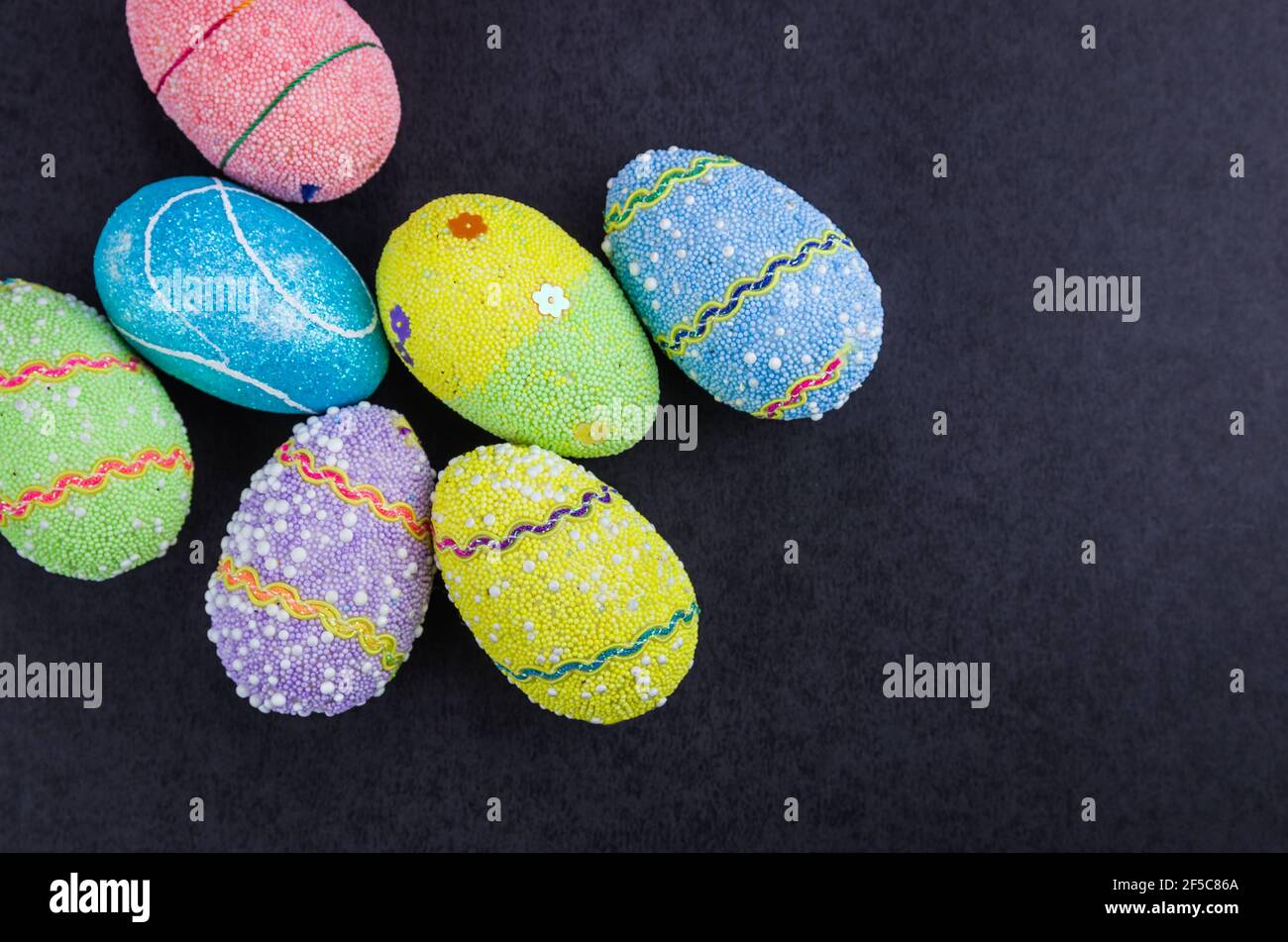 Colorful Easter eggs on a trendy black background. Stock Photo