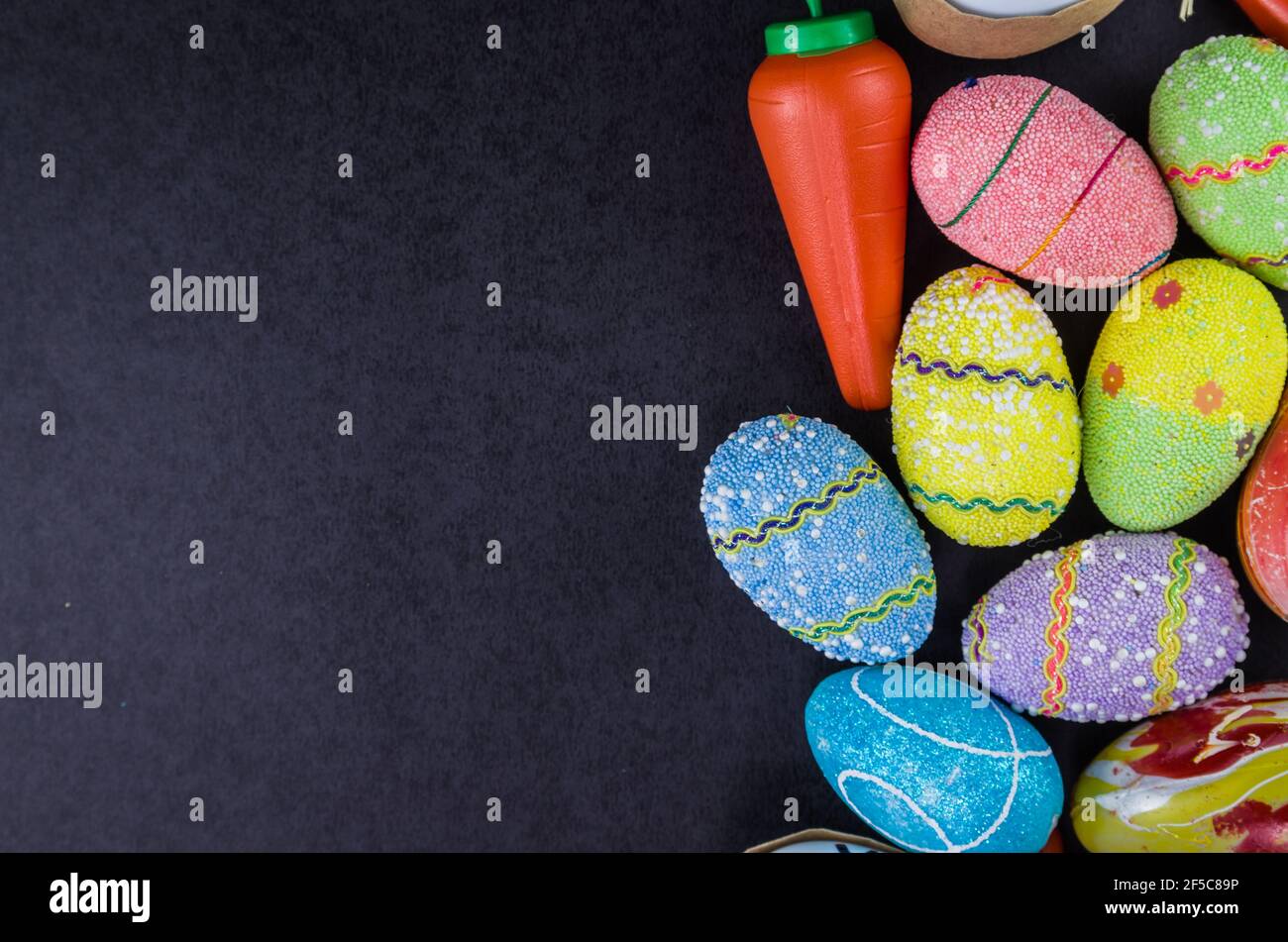 Colorful Easter eggs and other objects on a trendy black background for various Easter themed backgrounds Stock Photo