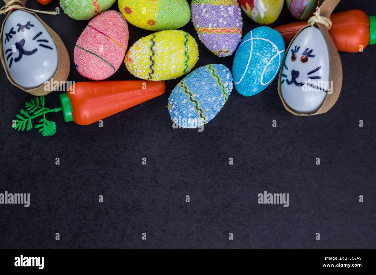 Colorful Easter eggs and other objects on a trendy black background for various Easter themed backgrounds Stock Photo