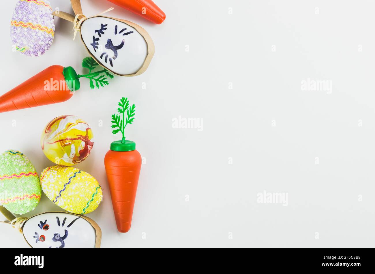 Colorful Easter eggs and other objects on a trendy white background for various Easter themed backgrounds Stock Photo