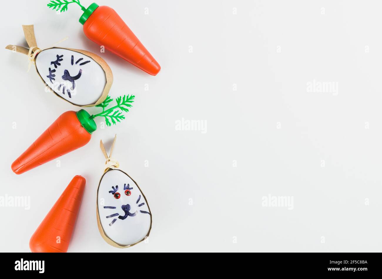 Colorful Easter eggs and other objects on a trendy white background for various Easter themed backgrounds Stock Photo