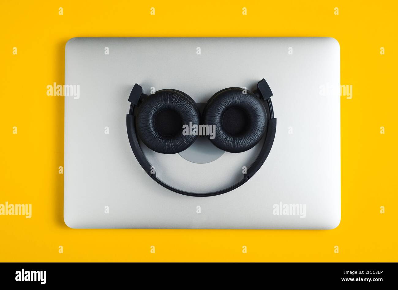 Headphones lie on notebook. Stock Photo