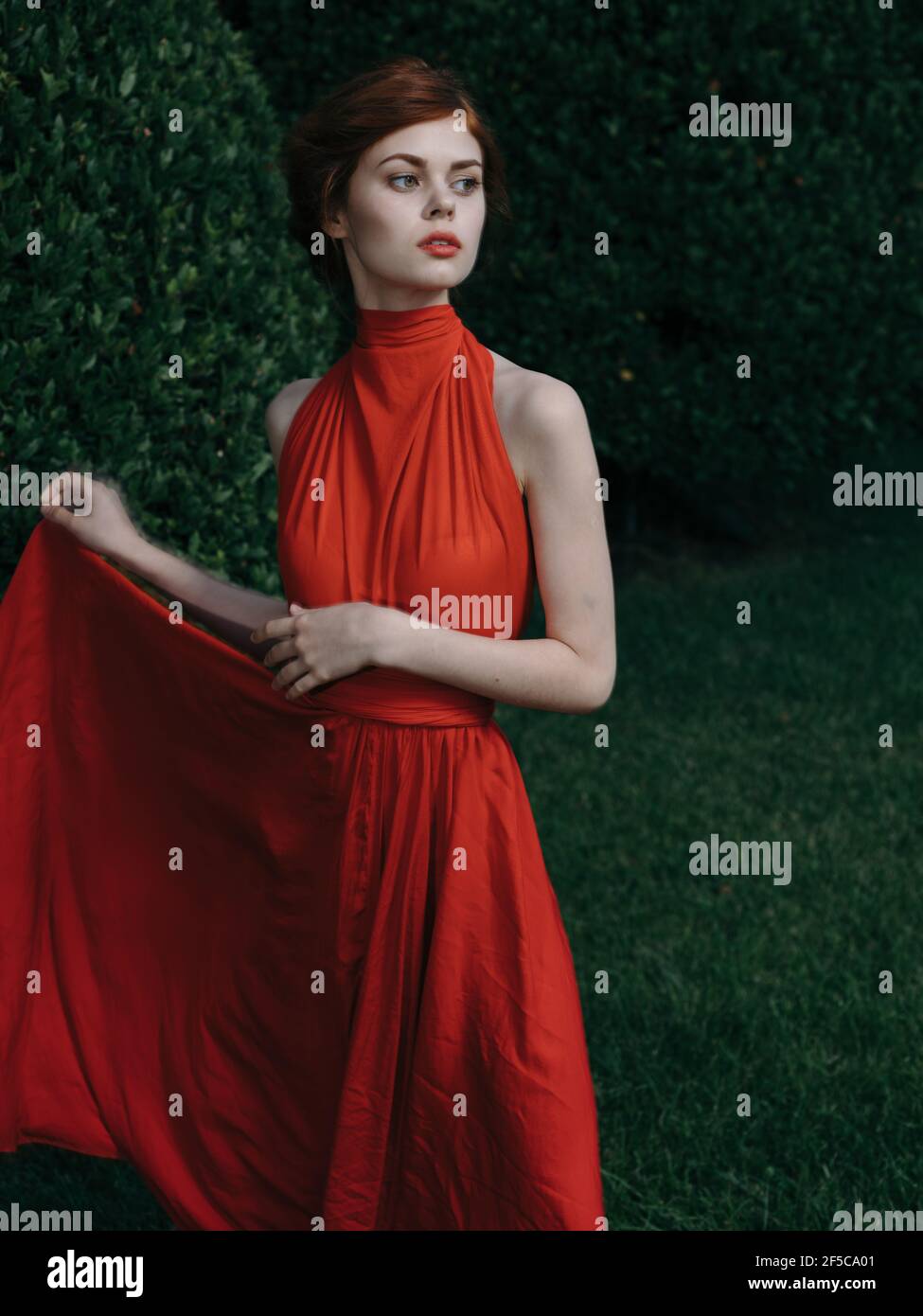 Pretty woman red dress Masquerade walk gothic style Stock Photo Alamy