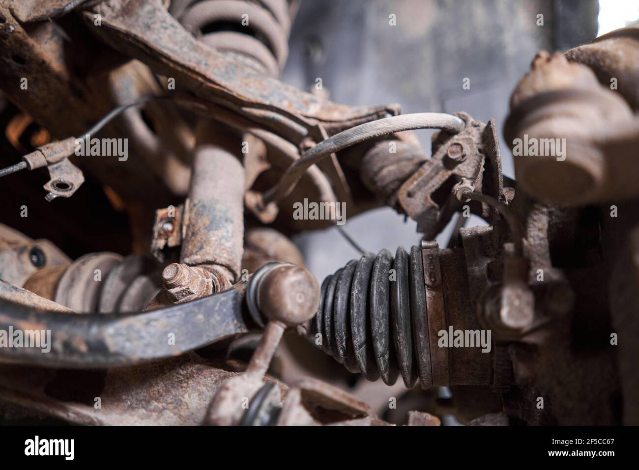 Inspects suspension, steering parts, tie rod ends. Car on a repair