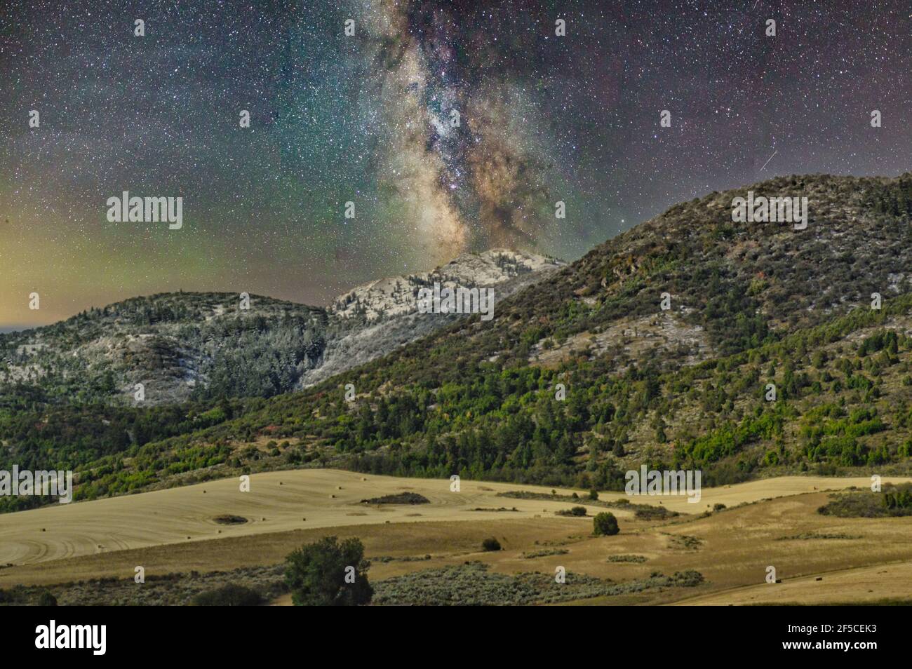 Milky way in a starry night sky above the forested mountains Stock ...