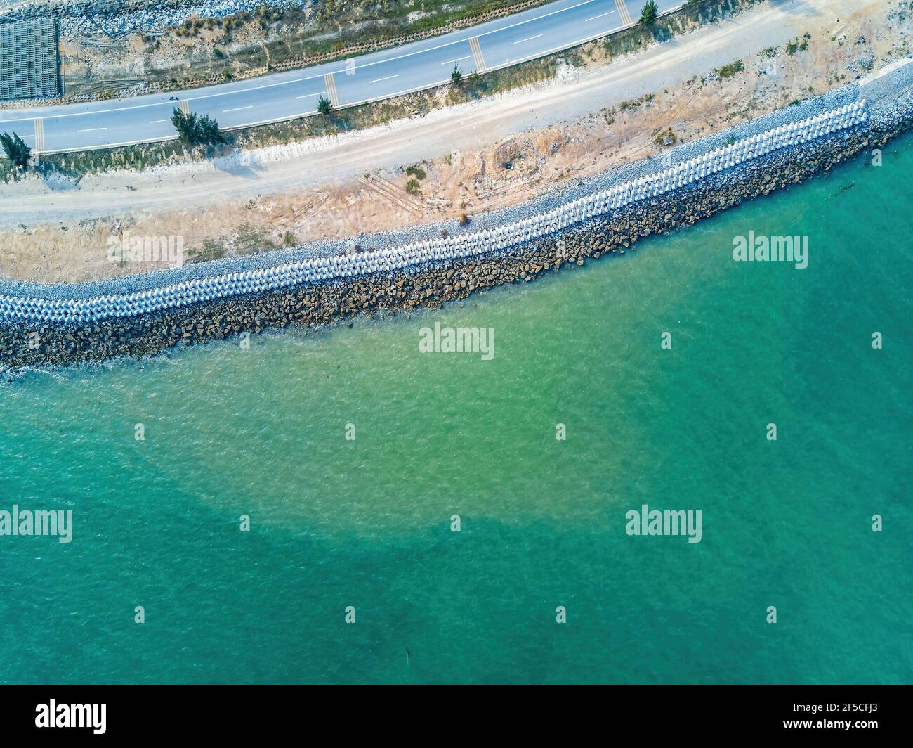 Cement block breakwater of coastal highway, aerial photography of