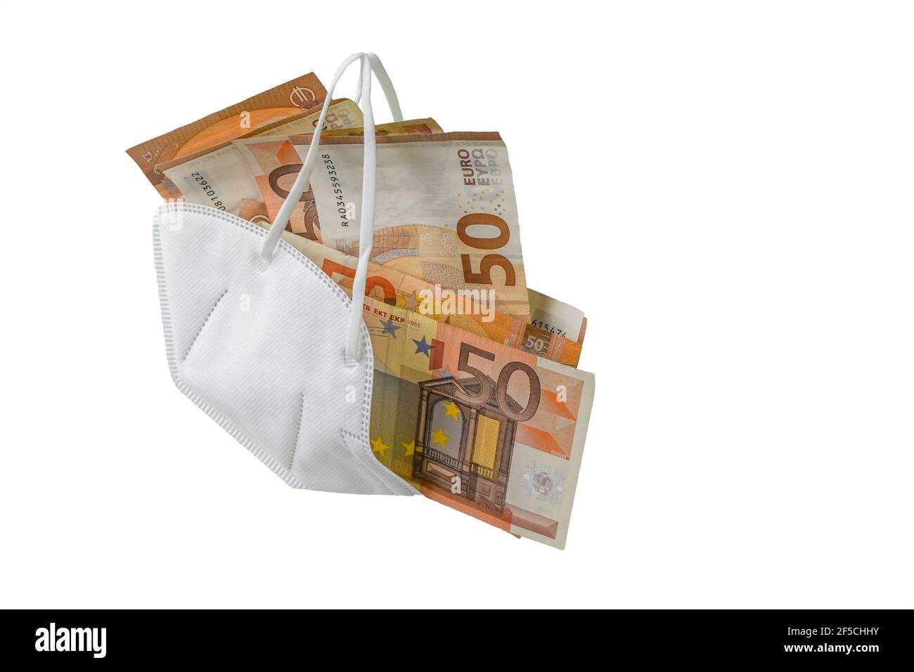 Medical ffp2 face mask against covid-19 virus filled with euro banknotes, concept for enrichment by corruption or rising costs of health care in pande Stock Photo