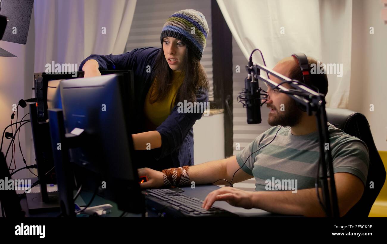 Boyfriend learning his girlfriend to play video games on