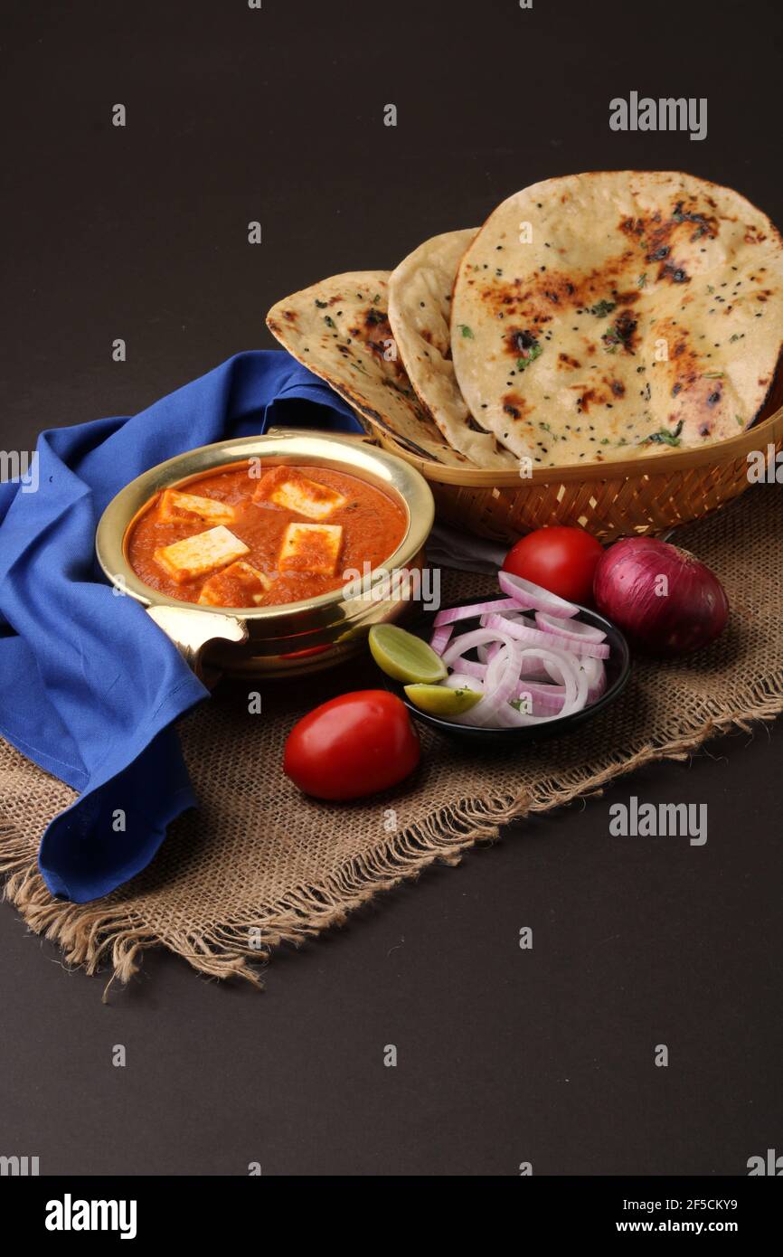 Paneer Butter Masala or Cheese Cottage Curry in serving a bowl or pan
