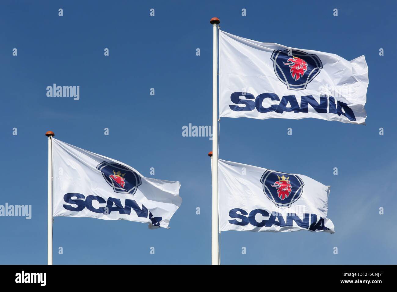 Vejle, Denmark - September 10, 2016: Scania flags waving in the sky. Scania is a major swedish automotive industry manufacturer of heavy trucks Stock Photo