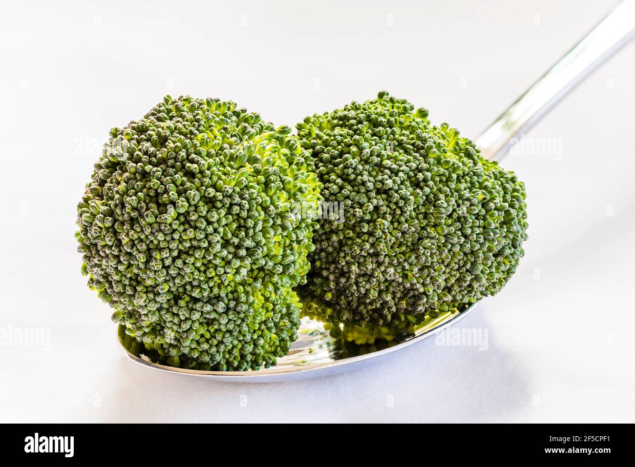 Closeup of two edible broccoli flower heads, London, UK Stock Photo Alamy