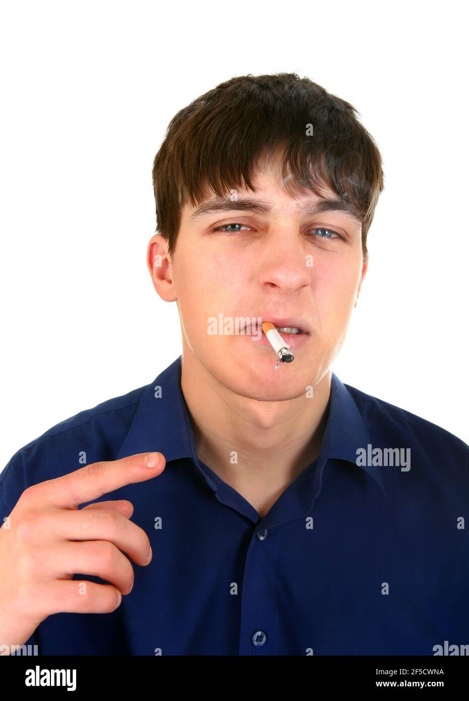 Displeased Young Man with a Cigarette on the White Background Stock Photo