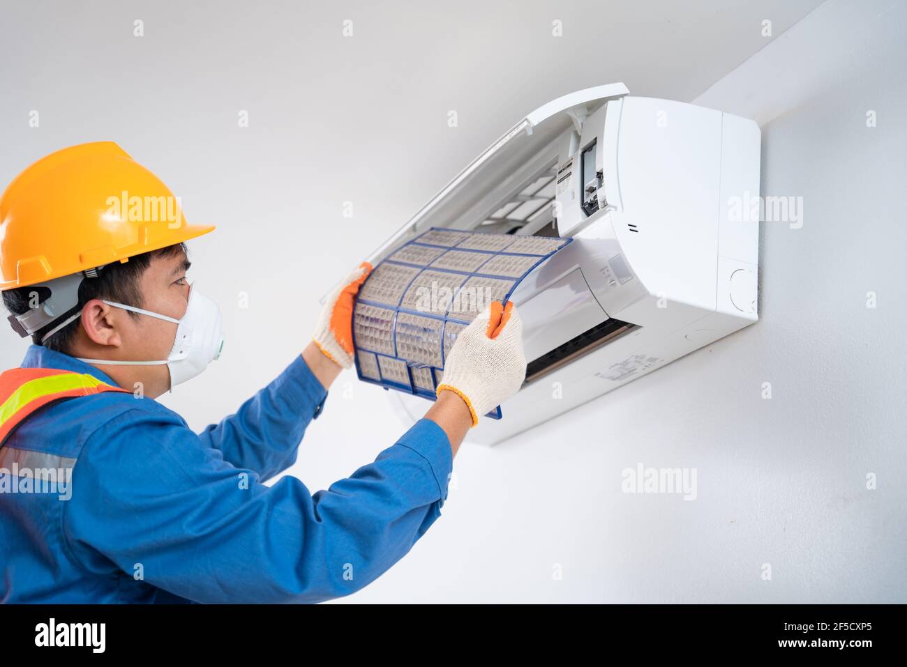 Asian male wear a safety mask to prevent dust technician is pulling a