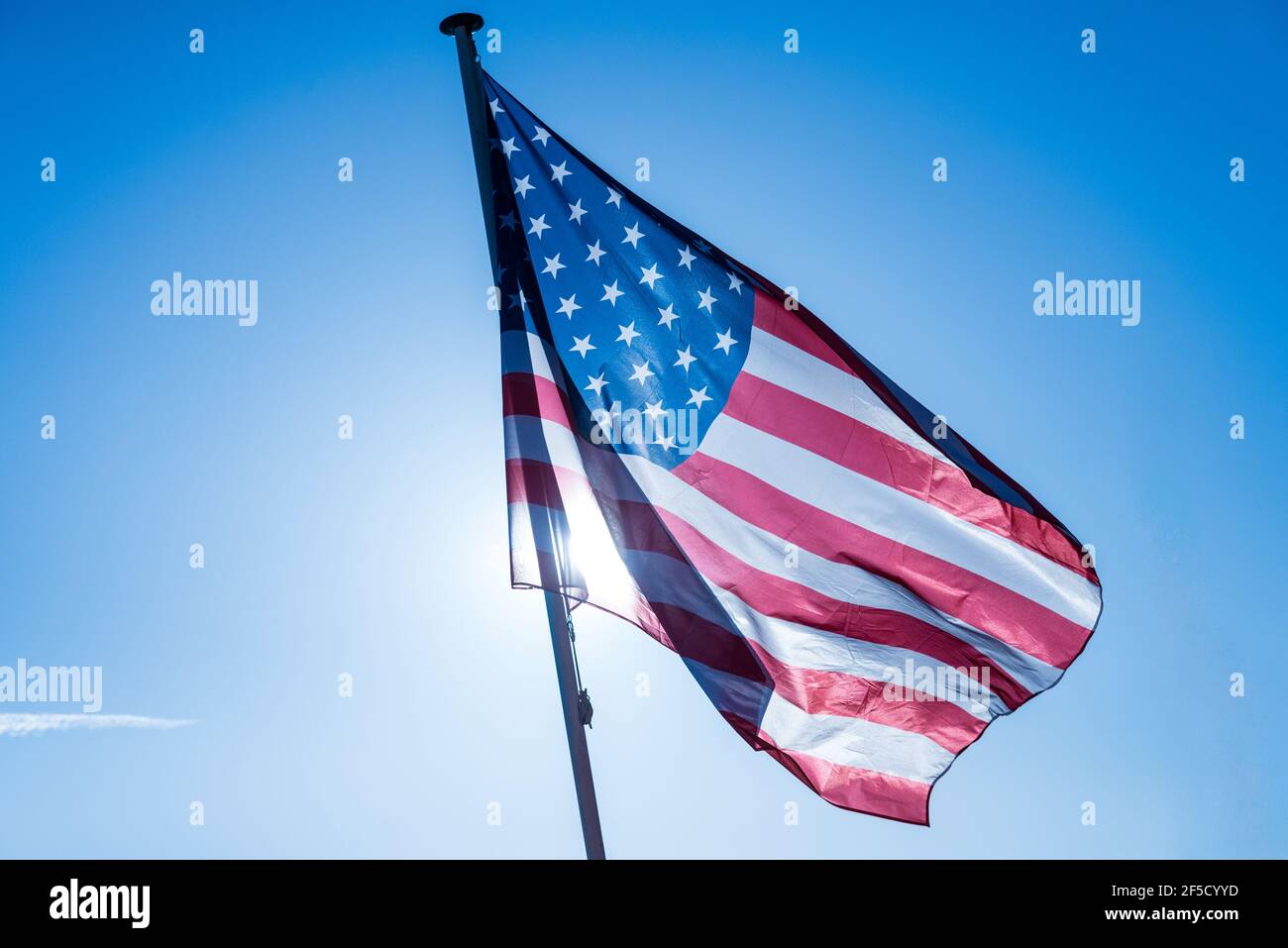 American flag waving in the clear blue sky Stock Photo - Alamy