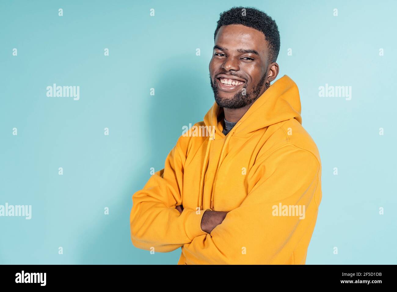 Stock photo of happy black boy wearing hoodie posing in studio shot ...