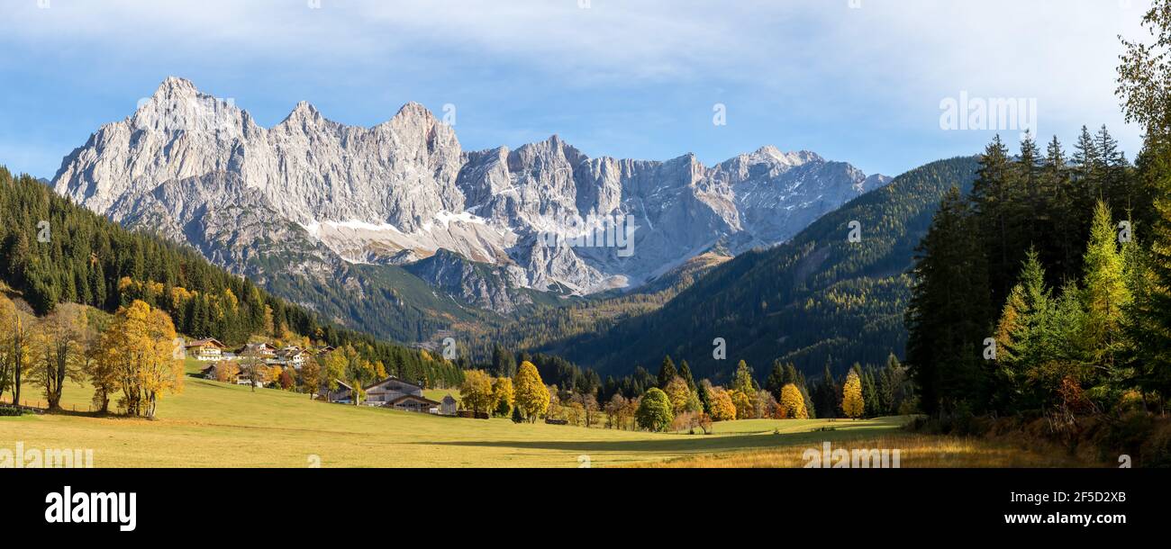 Dachstein mountain range in autumn with farms in the foreground Stock Photo