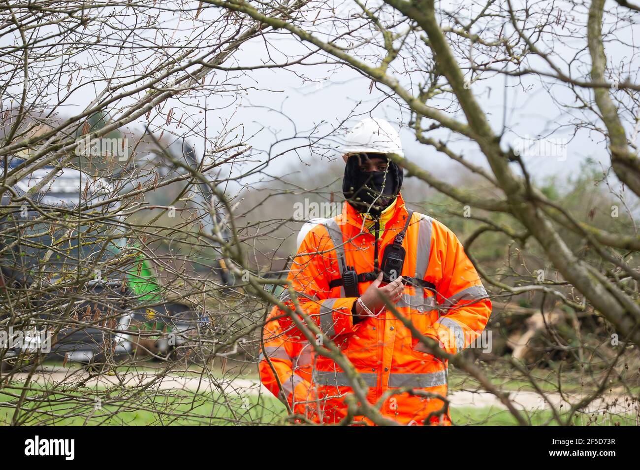 Aylesbury Vale, Buckinghamshire, UK. 24th March, 2021. HS2 have destroyed a huge area of trees and hedgerows off Rocky Lane despite it being bird nesting season. All life forms were being killed by HS2 today as they put the trees and hedgerows through a wood chipper. Three HS2 security guards were harrassing a photographer taking photographs of this destruction from a public highway. The High Speed 2 rail link from London to Birmingham is carving a huge scar across the Chilterns. Credit: Maureen McLean/Alamy Stock Photo