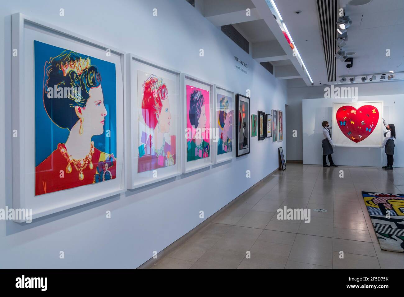 London, UK. 26th Mar, 2021. Andy Warhol, Queen Margarethe II of Denmark, from: Reigning Queens (Royal Edition) the set of four screenprints in colours with diamond dust, numbered R26/30 Estimate: £60,000-80,000 with Damien Hirst, Big Love, 2010, numbered 48/50, Estimate: £30,000-50,000 and other works - Behind Closed Doors: Preparations take place at Christie's ahead of the Prints & Multiples and Banksy: I Can't Believe You Morons Actually Buy This Sh*T Online Sales. The sales take place between 16-31 March and are both online. Credit: Guy Bell/Alamy Live News Stock Photo