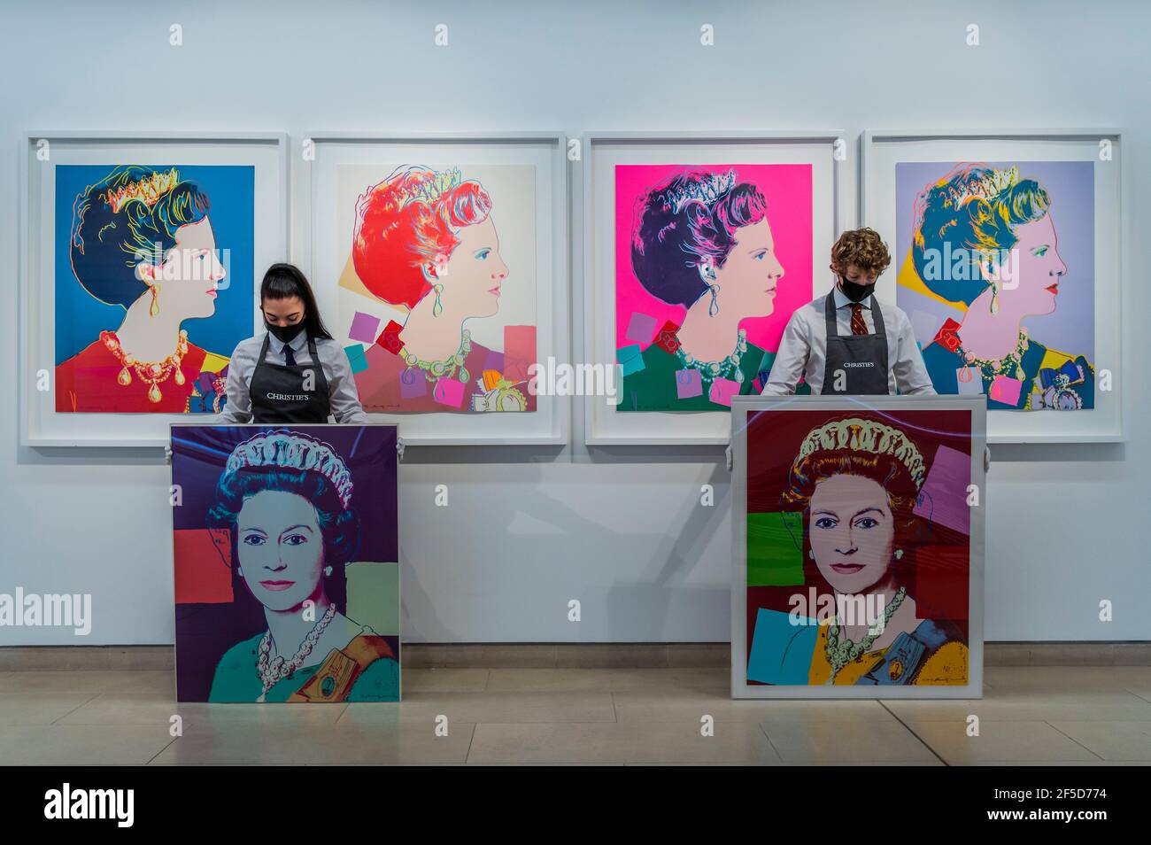 London, UK. 26 Mar 2021. Andy Warhol, Queen Elizabeth II, from: Reigning Queens (Royal Edition) screenprint in colours with diamond dust, 1985, a printer's proof, from the deluxe Royal Edition with diamond dust, Estimate: £100,000-150,000 and Queen Elizabeth II, from: Reigning Queens (L), 1985, numbered 7/40, Estimate: £70,000-100,000 with Queen Margarethe II of Denmark, from: Reigning Queens (Royal Edition) the set of four screenprints in colours with diamond dust, numbered R26/30 Estimate: £60,000-80,000and other works - Behind Closed Doors: Preparations take place at Christie's ahead of the Stock Photo