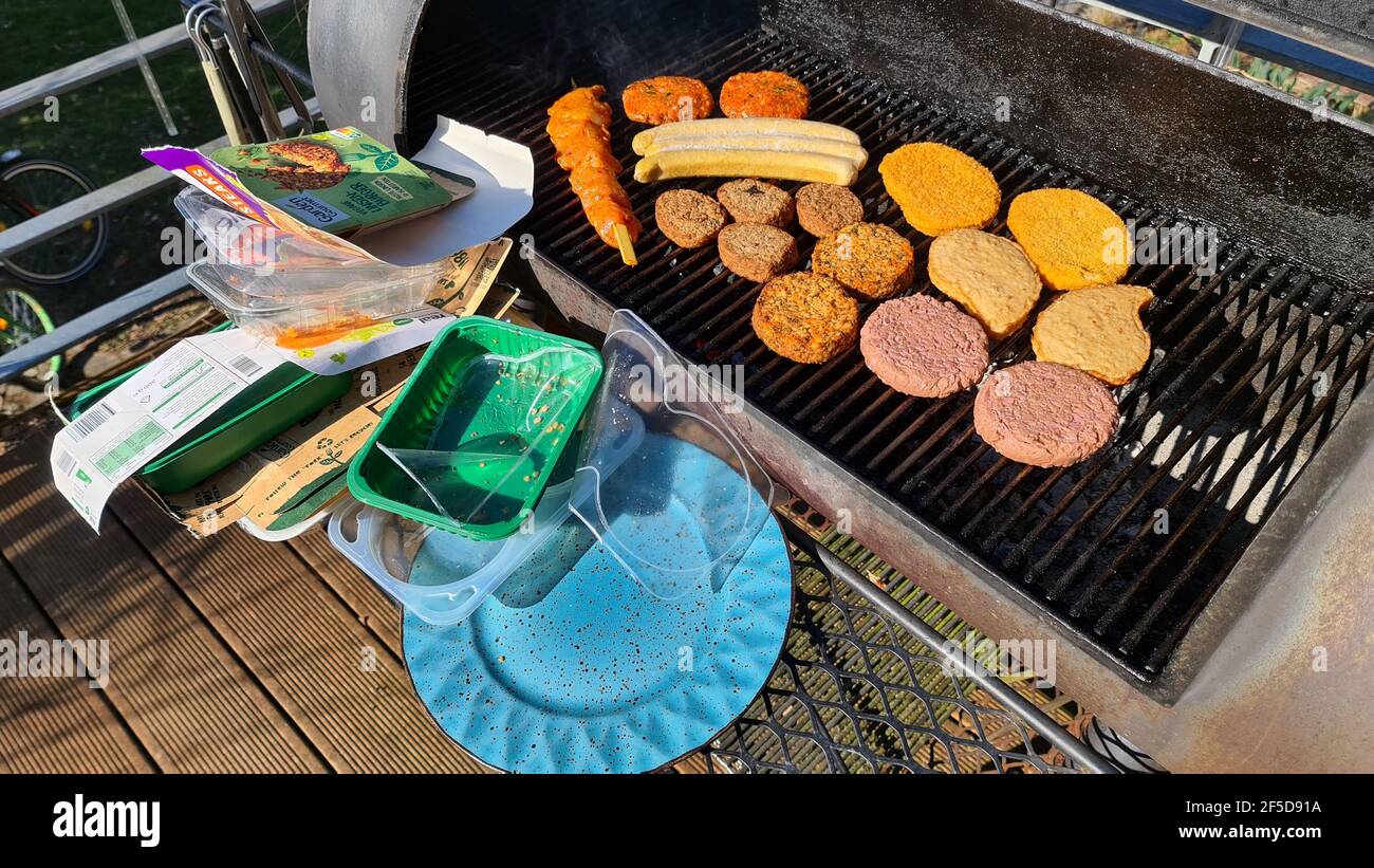 food to be grilled on a barbecue smoker, tons of packaging waste , Germany Stock Photo