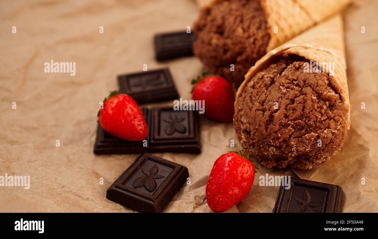 Chocolate ice cream in a waffle cone on craft paper background Stock