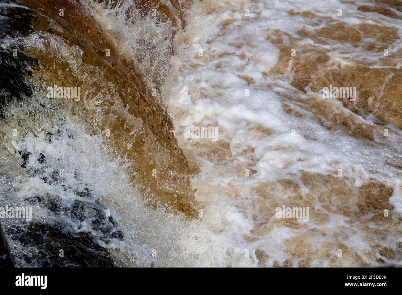 Waterfall on the River Ribble after autumnal downpour, churning water, North Yorkshire, UK Stock Photo