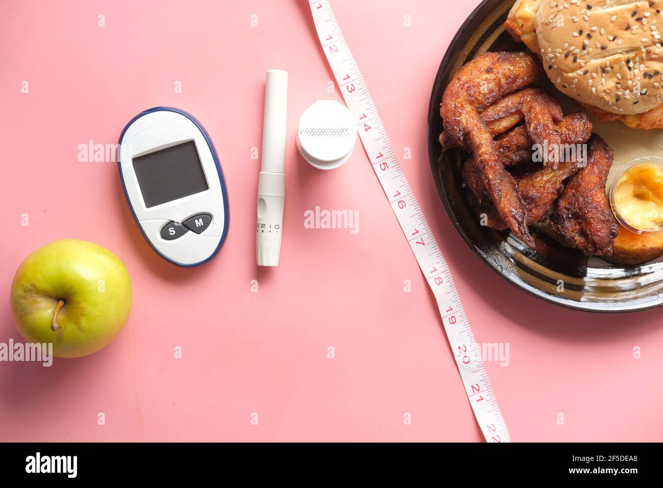 diabetic measurement tools and apple comparing with junk food Stock
