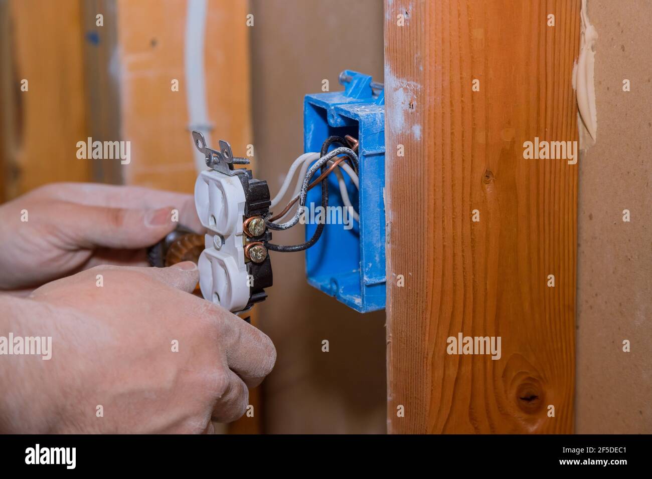 Removal and replacement old broken an electrical outlet into the wall box Stock Photo Alamy