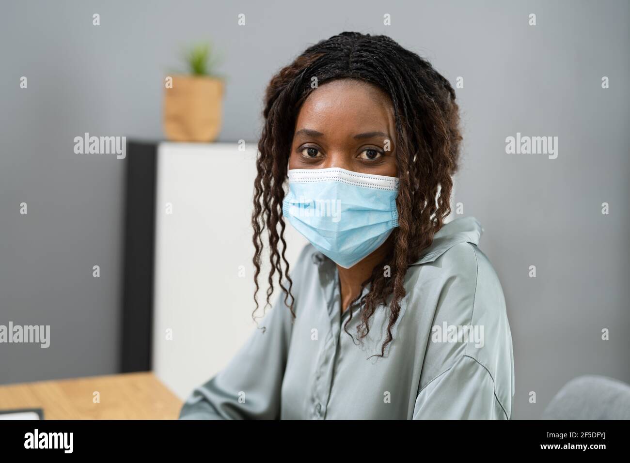 Black woman wearing facial mask hi-res stock photography and images - Alamy