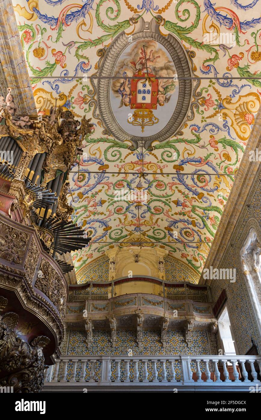 Interior of Sao Miguel chapel in the university of Coimbra, Portugal. Beautifully painted ceiling and the organ equipped with nearly 2,000 pipes Stock Photo
