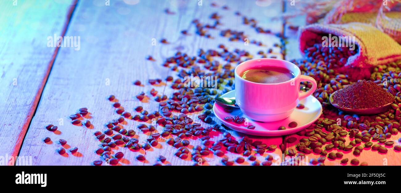 Coffee Cup and Coffee Beans on a Wooden Table Stock Photo