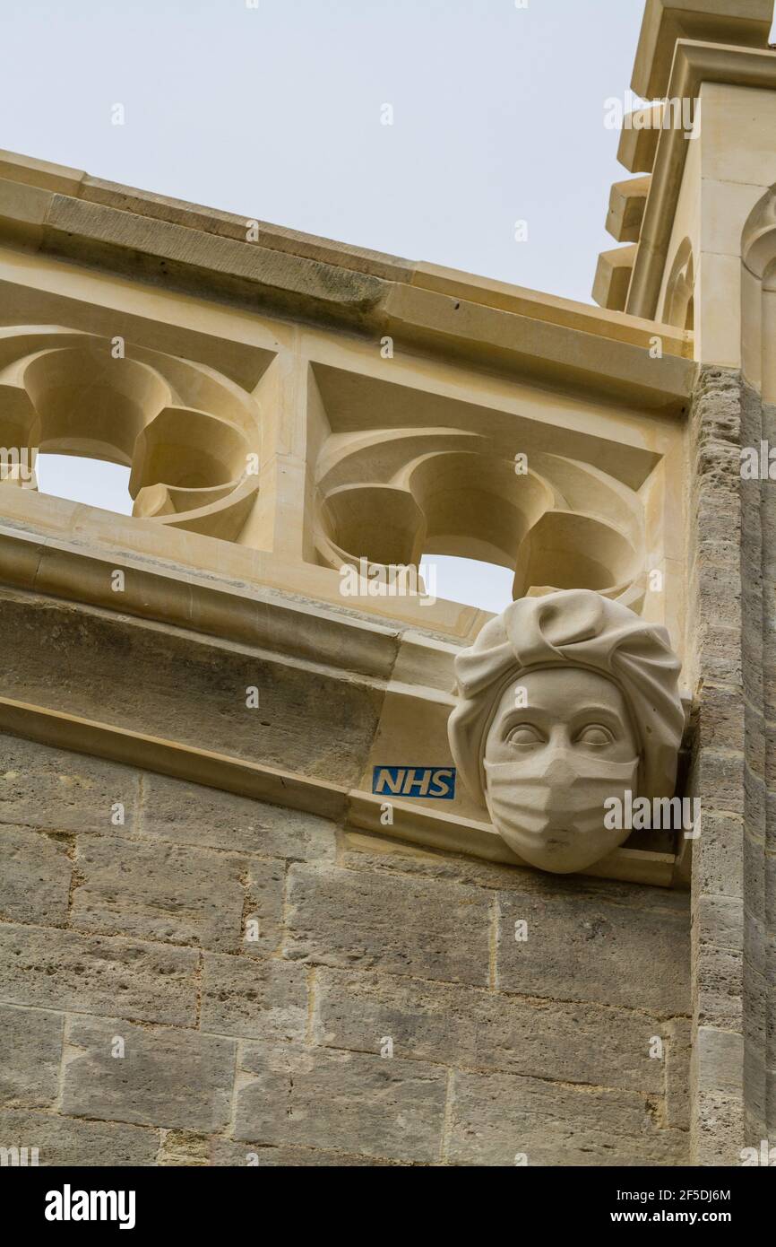 CHRISTCHURCH, ENGLAND – MARCH 26 2021: New stone carving of a masked PPE NHS Worker commemorating or celebrating the Covid 19 Epidemic NHS work on Chr Stock Photo