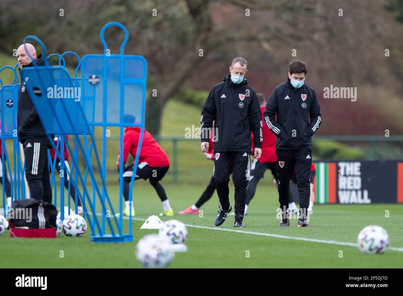 Hensol, Wales, UK. 26th Mar, 2021. FAW staff wearing facemasks during Wales national football team training at Vale Resort ahead of matches against Mexico and Czech Republic. Credit: Mark Hawkins/Alamy Live News Stock Photo