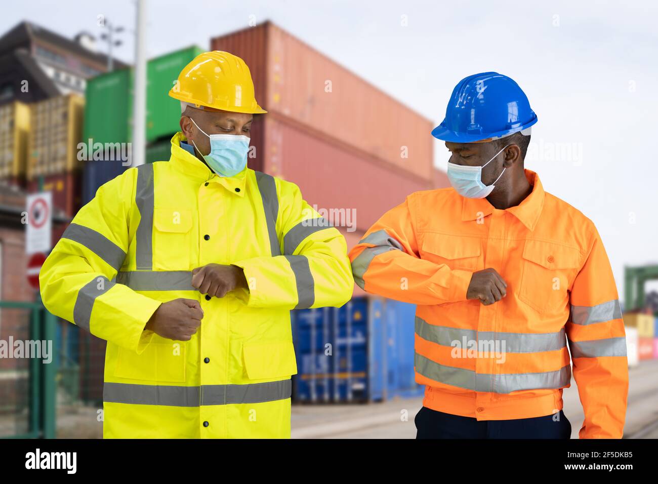 Construction Engineer Elbow Bump Wearing Covid Mask Stock Photo