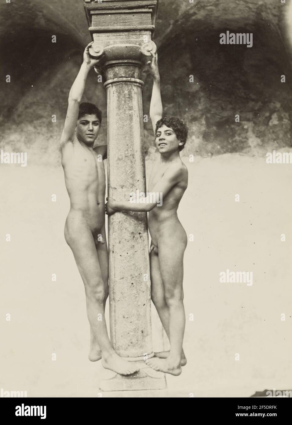 Two Boys Holding onto a Column. Baron Wilhelm von Gloeden (German, 1856 - 1931) Stock Photo