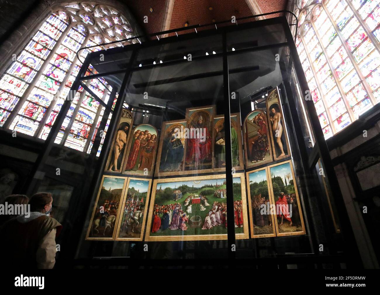 Visitors look at Flemish painter Jan Van Eyck's 15th century masterpiece  