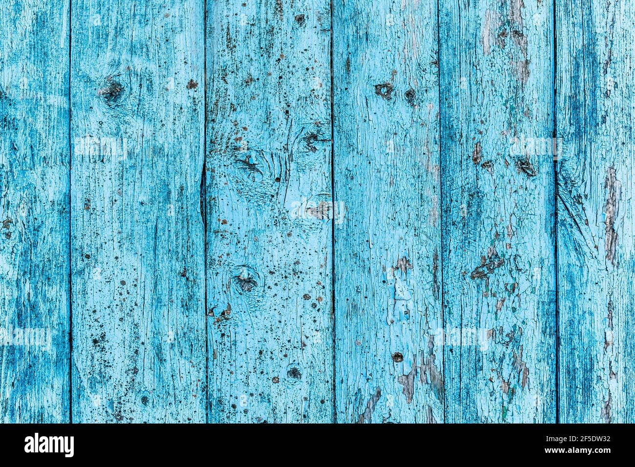 Seamless texture of old wooden fence with blue peeling paint, abstract plank background. Stock Photo
