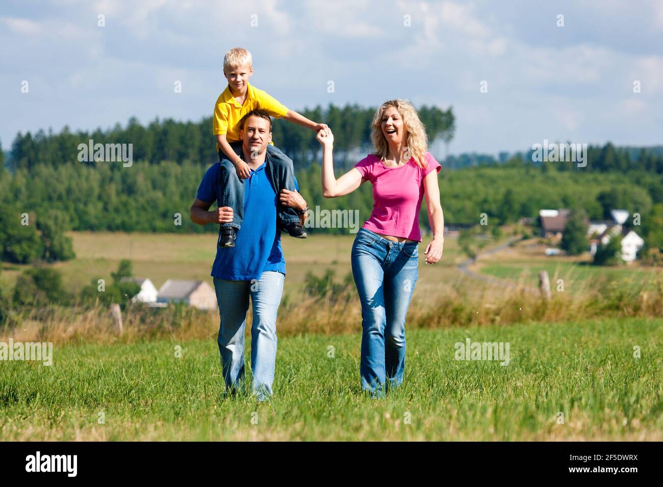 Woman does outdoor stretching with her personal trainer on a great summer day Stock Photo