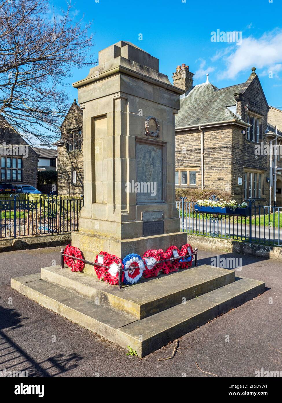 Pillar style war memorial in front of the primary school on the High Street in Starbeck Harrogate North Yorkshire England Stock Photo