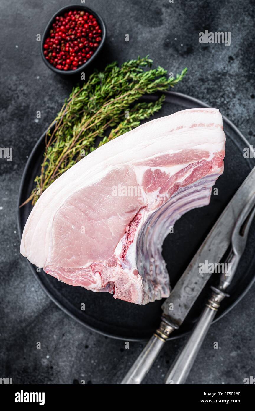 Fresh Raw whole rack of pork loin chops with ribs on a plate with meat