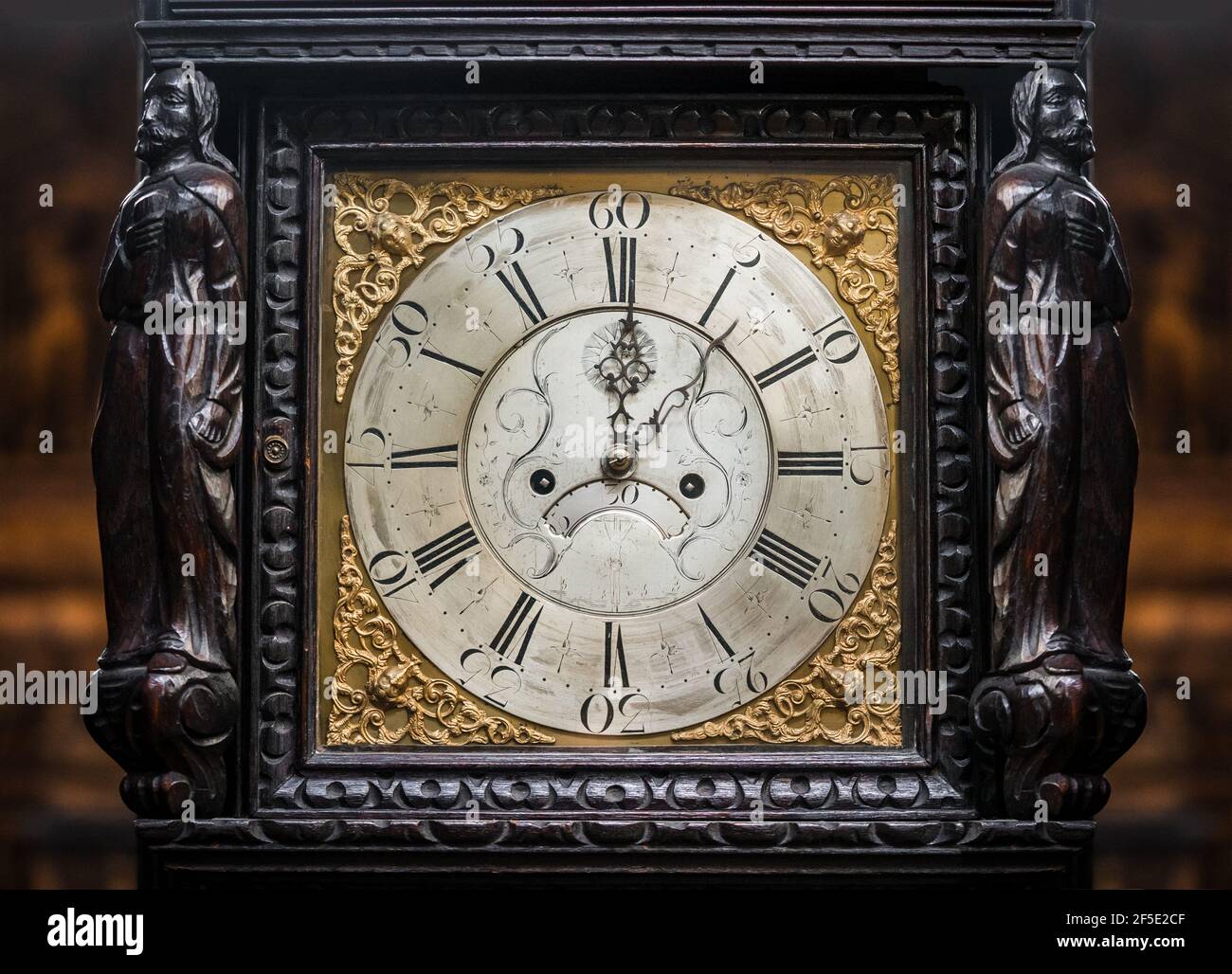 Beautiful old mechanical grandfather clock with christian religious