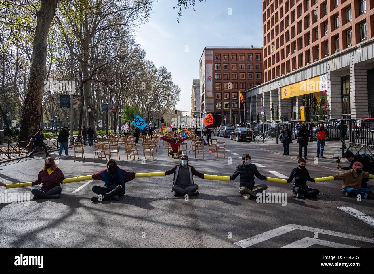 Madrid, Spain. 26th Mar, 2021. Climate change activists of Extinction Rebellion (XR) group chained themselves blocking the street in front of the Health Ministry, during a protest demanding actions against climate change. Credit: Marcos del Mazo/Alamy Live News Stock Photo